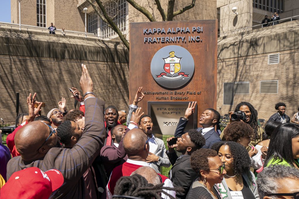 Members of Kappa Alpha Psi in front of their Sign