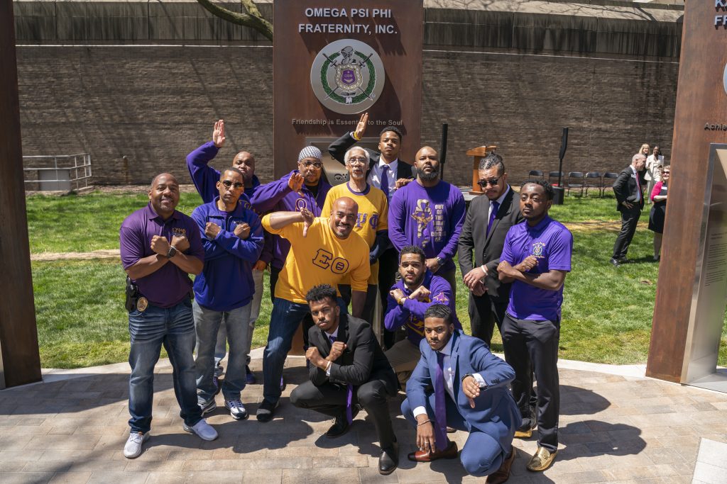Members of Omega Psi Phi Fraternity in front of their sign