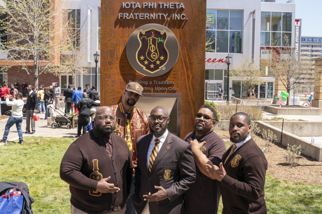 Members of Iota Phi Theta Fraternity in front of their Sign